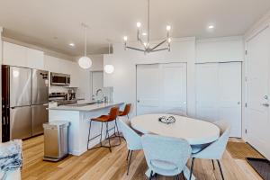 a kitchen and dining room with a table and chairs at Mellow on Meadow Mile 2A in Fraser