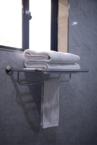 a towel rack with towels on it in a bathroom at Greenside Hotel in Arusha