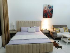 1 dormitorio con 1 cama grande y 1 sofá en Jumeirah Beach Villa en Dubái