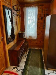 a small room with a refrigerator and a window at Patysiówka in Stronie Śląskie