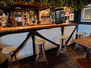 a bar with stools in a pub at The Green Dragon in Bishops Frome