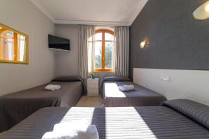 Postel nebo postele na pokoji v ubytování Hostal Ya