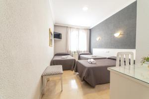 Postel nebo postele na pokoji v ubytování Hostal Ya