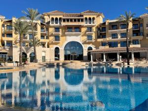 a large swimming pool in front of a building at Lakeview Residence 'Casa Naranjas' Mar Menor Golf and Leisure Resort in Torre-Pacheco