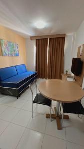 a hospital room with a blue bed and a table at Apartamentos Boulevard in Caldas Novas