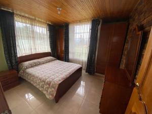 En eller flere senge i et værelse på Cabañas Villa del Dorado