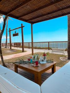 a table on a patio with a basketball hoop at Arraial Bangalô Praia Hotel in Arraial d'Ajuda