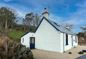 a small white building with a blue roof at 176 Marrell in Helmsdale