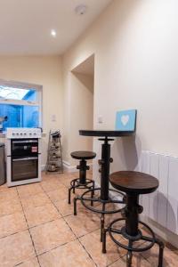 a kitchen with two tables and a laptop on the wall at 176 Marrell in Helmsdale