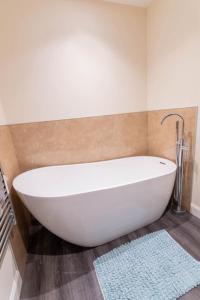 a white bath tub in a bathroom with a rug at 176 Marrell in Helmsdale