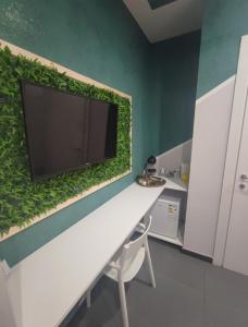 a living wall with a tv on top of it at Eden guest house in Rome