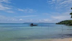 a body of water with a pier in the middle at The Hut Koh Mak Sea View in Ko Mak