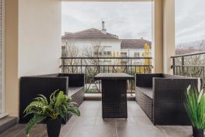 a balcony with chairs and a table on a balcony at Luxueux Appartement proche Disneyland in Bussy-Saint-Georges