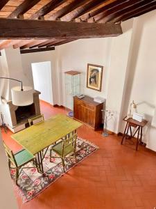 a living room with a wooden table and chairs at Spacious apartment near Arno river in Florence