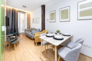 a living room with a table and chairs at LA CATOLICA GUEST HOUSE in Granada