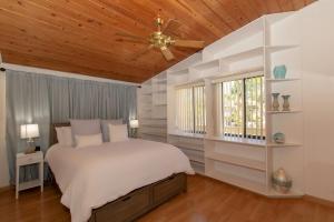 a bedroom with a bed and a ceiling fan at Bay Therapy in Key Largo +35 photos