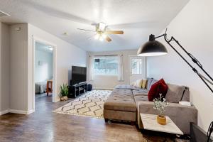a living room with a couch and a ceiling fan at Carlton Cottage in Meridian
