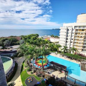 an aerial view of a resort with a swimming pool at Beto Carrero, vista Espetacular do mar, Home Club in Penha