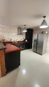 a kitchen with a stainless steel refrigerator and appliances at casa campestre escobero in Envigado