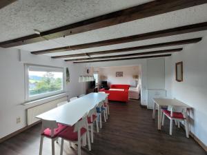 a living room with a table and chairs and a couch at Holiday home near the ski lift in Winterberg