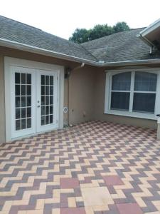 a house with a brick patio in front of it at Brand new studio apartment in Vero Beach