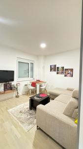 a living room with a couch and a table at Apartman Sunce Bjelasnica in Bjelašnica