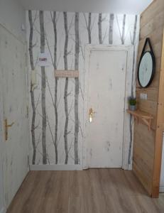 a room with a wall with trees painted on it at Apartamento El sarrio in Candanchú