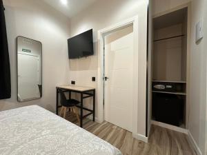 a small room with a bed and a small table at CC Opera Suites in Madrid