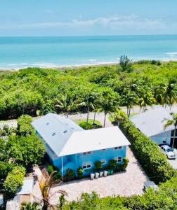 an aerial view of a blue house on the beach at Secluded Beachfront Vibes - Surf & Pet Friendly in Fort Pierce