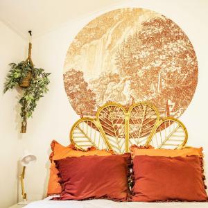a bedroom with a bed with a gold head board at StayatSas Tiny House Sam in de bossen op de Veluwe! in Epe +83 photos