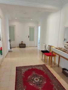 a living room with a red rug on the floor at BENSASSI Urban Escape Premium in La Marsa