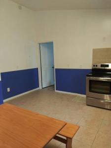 an empty kitchen with a stove and a table at mini Apartment in sunshine city Florida in Vero Beach