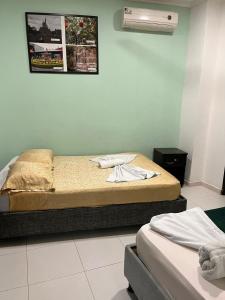Postel nebo postele na pokoji v ubytování SGH Rodadero Suites