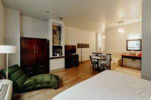 a large room with a bed and a dining room at Mercer Hotel Downtown; BW Premier Collection in Stratford