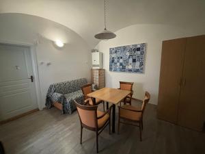 a living room with a table and chairs and a couch at DH Duomo III apartment in Košice