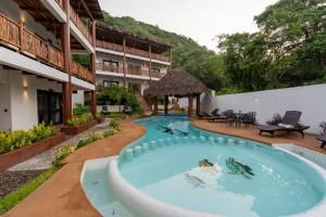 a swimming pool in the middle of a resort at Hotel Alfa Troncones Mexico in Troncones
