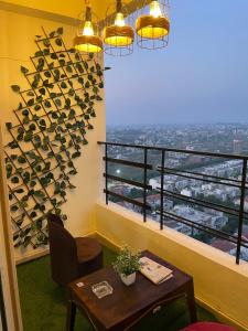 a room with a table and a window with wine bottles at Serene Stay India in Greater Noida