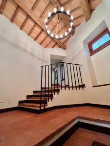 a room with a staircase and a ceiling with a chandelier at Serravalle Castle Apartment in Serravalle