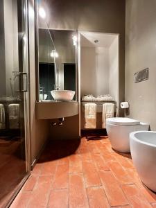 a bathroom with two sinks and a tub and a toilet at Serravalle Castle Apartment in Serravalle