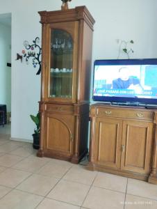 a entertainment center with a tv and a cabinet at Departamento en Buenos Aires, La boca 3 amb in Buenos Aires