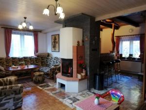 a living room with a couch and a fireplace at Chata na Čertove in Štôla
