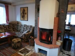 a living room with a fireplace in a living room at Chata na Čertove in Štôla