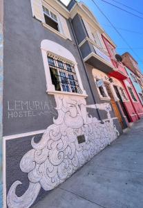 a building with a mural on the side of it at Lemuria Hostel in Valparaíso