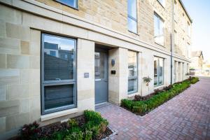a brick building with windows and a driveway at Lambert House Two in Harrogate