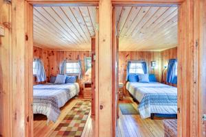 a bedroom with two beds in a wooden house at Autumnsong Fireside Cabin Near Dtwn Buena Vista! in Buena Vista