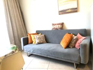 a blue couch with pillows on it in a living room at Estudio en Tenerife sur, Parque Santiago 2 in Arona