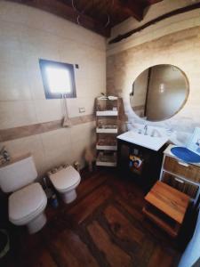 La salle de bains est pourvue de toilettes, d'un lavabo et d'un miroir. dans l'établissement Espejos de monte, à San Miguel del Monte