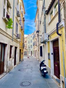 a scooter parked on a street in an alley at Piccolo Pirano in Piran