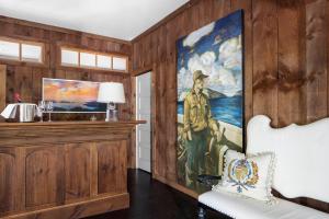 a room with a painting of a man on the wall at Cape Arundel Inn - Club House in Kennebunkport
