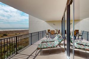 a balcony with chairs and a view of the ocean at Holiday Isle 413 in Dauphin Island